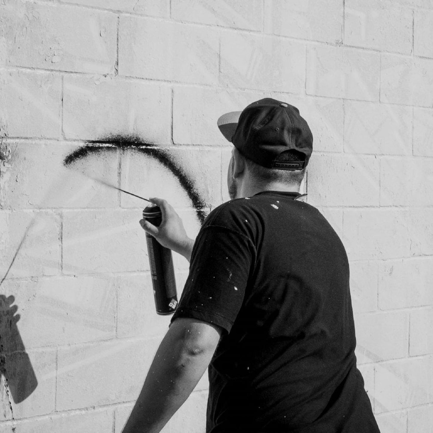 Krink X MTN K750 Black Spray Paint being sprayed on a wall.