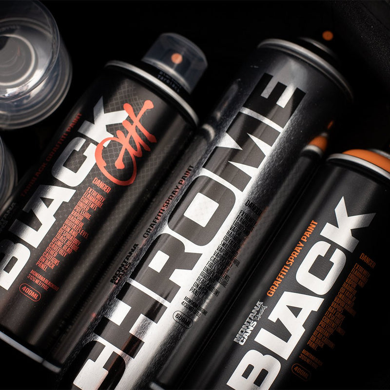 Montana cans lined up on a black background