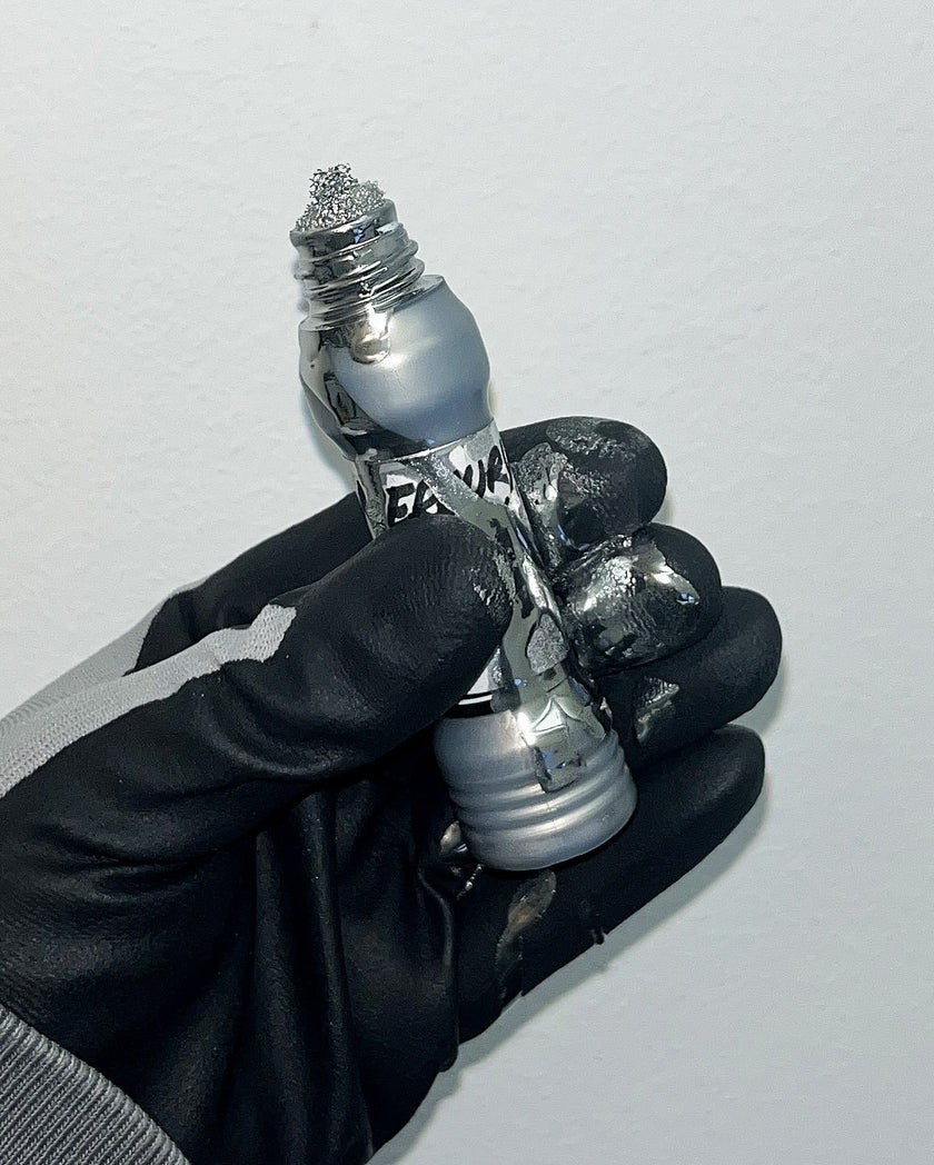 Grog Mercury chrome squeezer marker with chrome ink dripping from nib, graffiti mop marker close-up