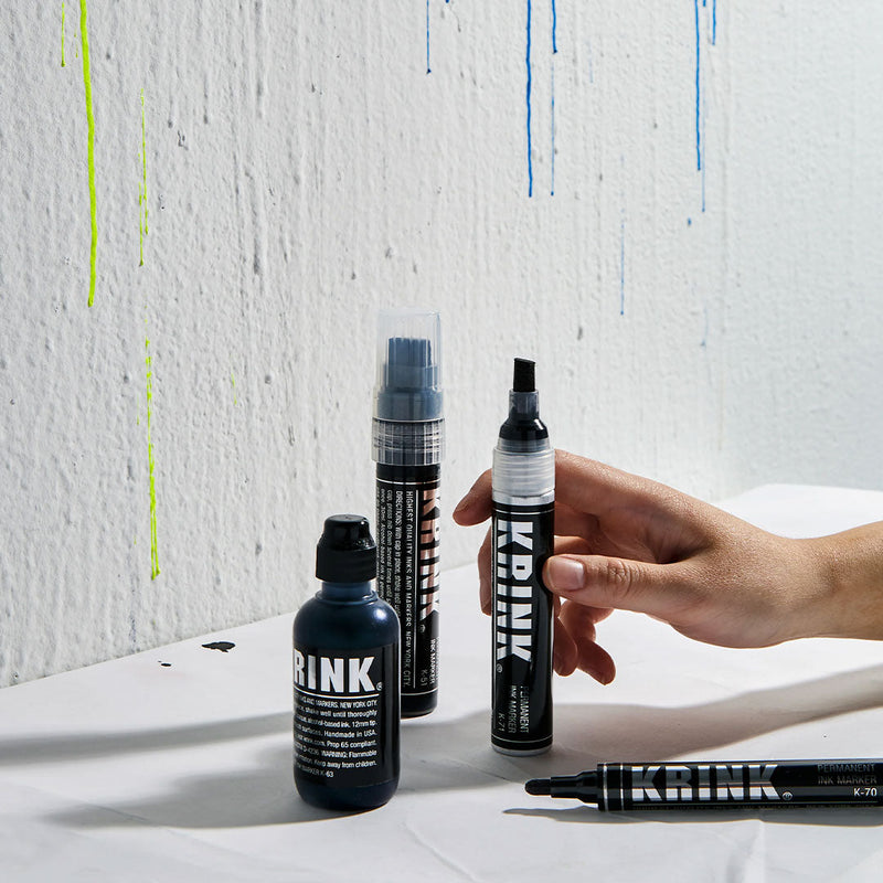Krink products with dripping paint on wall