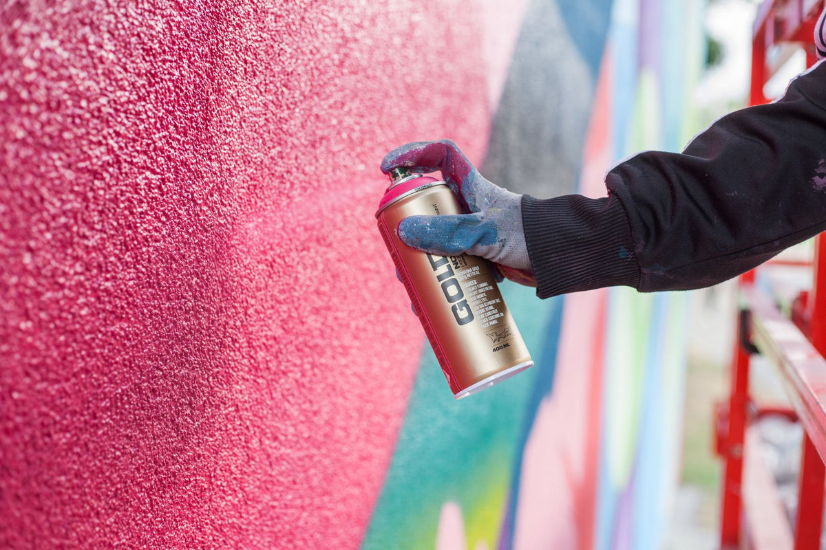 Person spraying with Montana can
