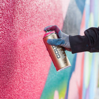 Montana Gold being sprayed on a concrete wall