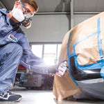 Person spraying car using Spray Max paint.